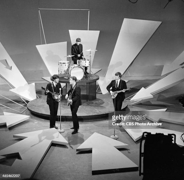 Members of British Rock group the Beatles perform on the set of 'The Ed Sullivan Show' at CBS's Studio 50, New York, New York, February 8, 1964....
