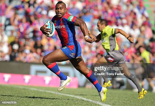 Akuila Uate of the Knights runs the ball downfield during the round one NRL match between the Newcastle Knights and the New Zealand Warriors at...