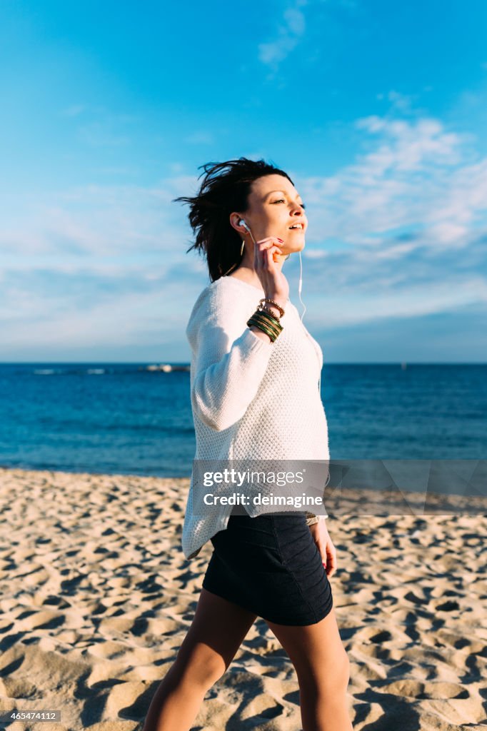 Woman on the beach enjoying sun and sea.