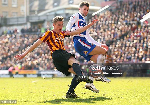 Stephen Darby of Bradford City takes a shot on goal under pressure from Oliver Norwood of Reading during the FA Cup Quarter Final match between...