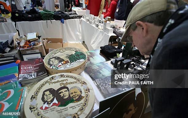 Man looks at a Bodhran , an Irish Drum, in memory of Bobby Sands, a member of the Provisional Irish Republican Army who was the first who died on...