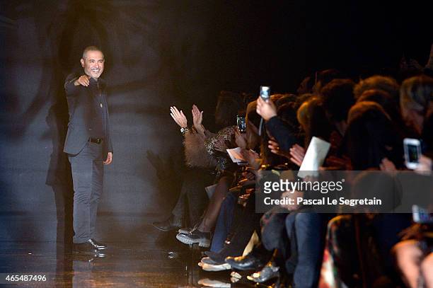 Designer Elie Saab acknowledges the applause of the public after his show as part of the Paris Fashion Week Womenswear Fall/Winter 2015/2016 on March...