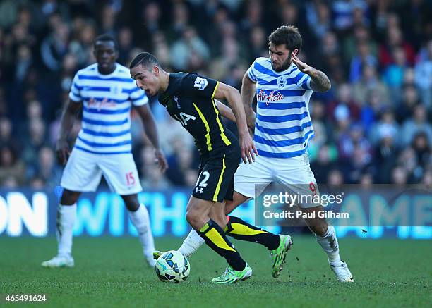 Nabil Bentaleb of Spurs evades Charlie Austin of QPR during the Barclays Premier League match between Queens Park Rangers and Tottenham Hotspur at...