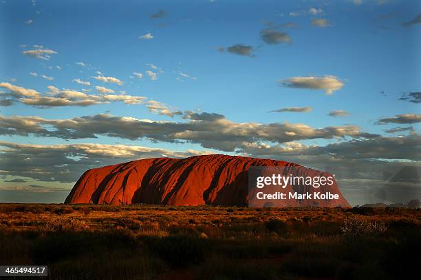 Uluru is seen at as the sun sets on November 27, 2013 in Uluru-Kata Tjuta National Park, Australia. Uluru/ Ayers Rock is a large sandstone formation...