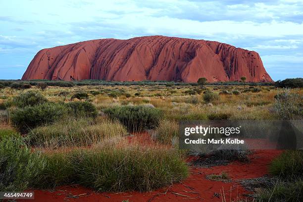 Uluru is seen at as the sun sets on November 27, 2013 in Uluru-Kata Tjuta National Park, Australia. Uluru/ Ayers Rock is a large sandstone formation...