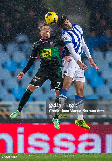 Xabier Prieto of Real Sociedad duels for the ball with Aaron Niguez of Elche FC during the La Liga match between Real Sociedad de Futbol and Elche FC...