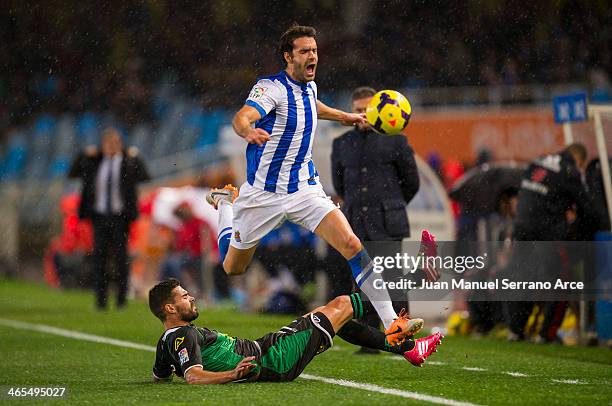 Xabier Prieto of Real Sociedad duels for the ball with Alberto Botian of Elche FC during the La Liga match between Real Sociedad de Futbol and Elche...