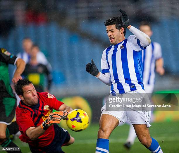 Carlos Vela of Real Sociedad duels for the ball with Tono Martinez of Elche FC during the La Liga match between Real Sociedad de Futbol and Elche FC...