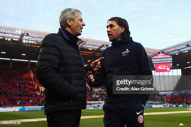 Head coaches Martin Schmidt of Mainz and Lucien Favre of Moenchengladbach chat prior to the Bundesliga match between 1. FSV Mainz 05 and Borussia...