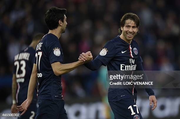 Paris Saint-Germain's Argentinian midfielder Javier Pastore celebrates with Paris Saint-Germain's Brazilian defender Maxwell after scoring his team's...