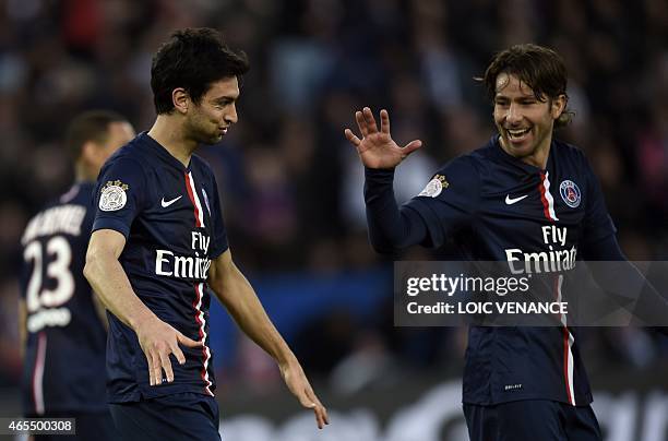 Paris Saint-Germain's Argentinian midfielder Javier Pastore celebrates with Paris Saint-Germain's Brazilian defender Maxwell after scoring his team's...