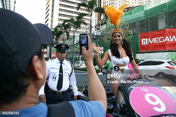 Man takes a photo of candidate number 9, Maolin Yalung of Pampanga, at the Araneta Center in Cubao, Quezon City. Thirty-four Binibining Pilipinas...