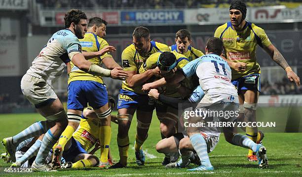 Clermont's French flanker Julien Bonnaire is tackled as he advances with the ball during the French Top 14 rugby union match between Clermont and...