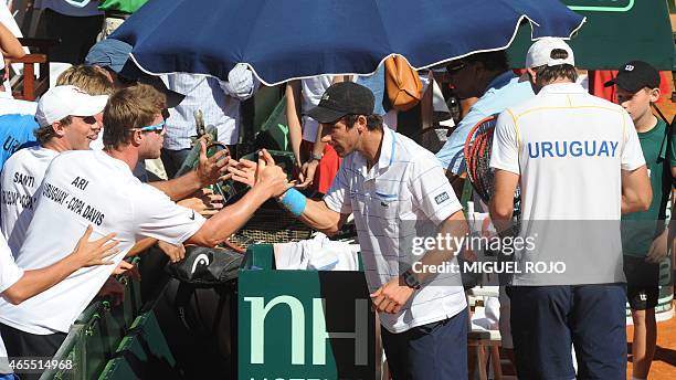 Uruguay's tennis player Pablo Cuevas celebrates after defeating Colombian Sebastian Cabal and Robert Farah during their Davis Cup American zone...