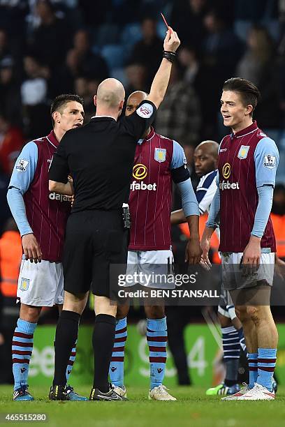 Aston Villa's English midfielder Jack Grealish is given a red card during by referee Anthony Taylor during the FA Cup quarter-final match between...