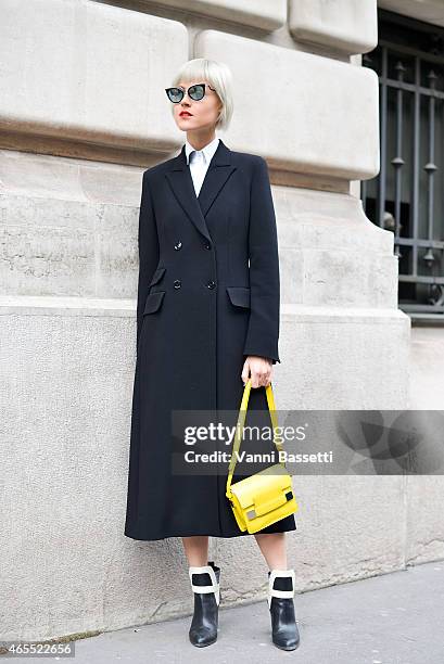 Linda Tol poses wearing a Max Mara coat, Sergio Rossi shoes, Fendi sunglasses and Delvaux bag on Day 5 of Paris Fashion Week Womenswear FW15 on March...