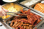 Breakfast or Brunch Buffet Serving Bacon with Tongs