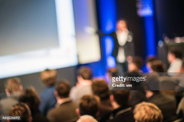 large group of people listening to a presentation - business meeting blurry stock pictures, royalty-free photos & images