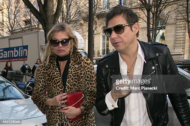 Kate Moss and husband Jamie Hince arrive at the 'Yves Saint Laurent' store on Avenue Montaigne on March 7, 2015 in Paris, France.