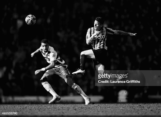 Billy Knott of Bradford City strikes the ball as Daniel Williams of Reading closes during the FA Cup Quarter Final betweeen Braford City and Reading...