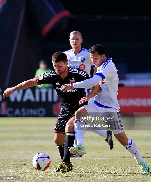 Perry Kitchen of D.C. United and Dilly Duka of Montreal Impact go after the ball during the first half at RFK Stadium on March 7, 2015 in Washington,...