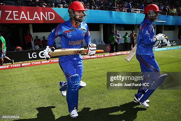 Usman Ghani and Javed Ahmadi of Afghanistan walk onto the field during the 2015 ICC Cricket World Cup match between New Zealand and Afghanistan at...