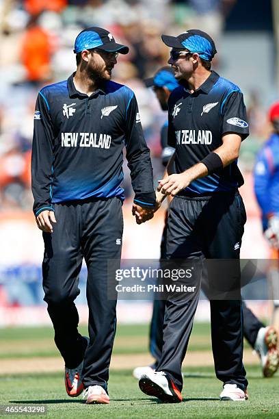 Daniel Vettori of New Zealand is congratulated by Tim Southee at the end of his bowling spell during the 2015 ICC Cricket World Cup match between New...