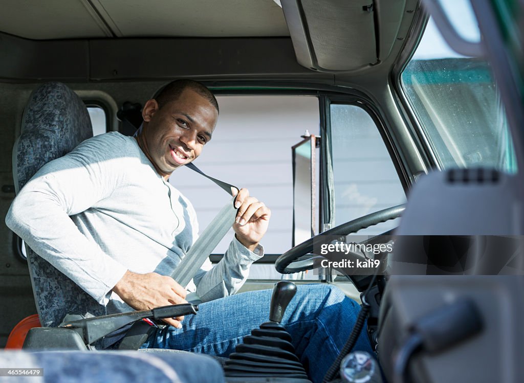 African American man driving truck