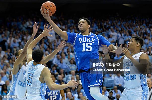 Jahlil Okafor of the Duke Blue Devil drives between defenders Brice Johnson, Marcus Paige and Marcus Paige of the North Carolina Tar Heels during...