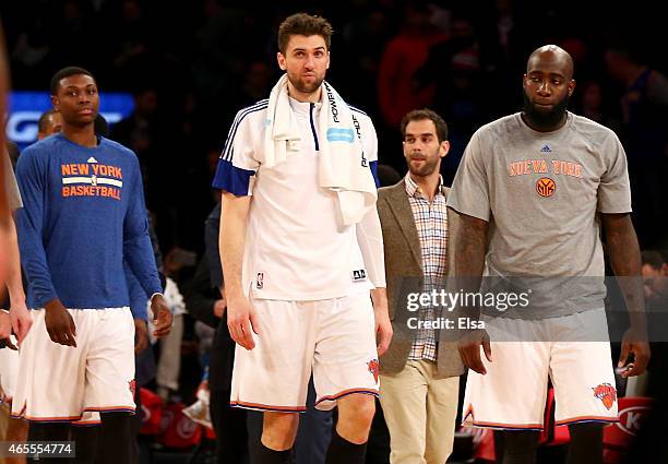 Andrea Bargnani of the New York Knicks walks off the court with teammates Cleanthony Early,Jose Calderon and Quincy Acy after the game against the...