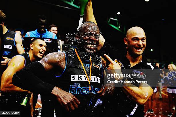 Assistant Coach Judd Flavell of the Breakers pours champagne on Cedric Jackson of the Breakers after winning game two of the NBL Grand Final series...
