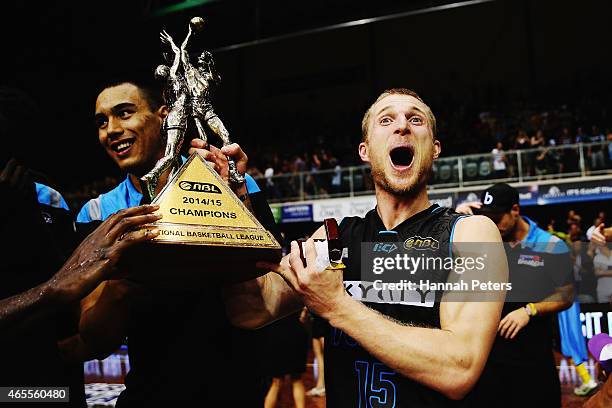 Rhys Carter of the Breakers celebrates with the trophy after winning game two of the NBL Grand Final series between the New Zealand Breakers and the...