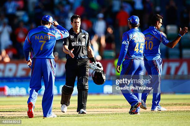 Ross Taylor of New Zealand shakes hands with Samiullah Shenwari of Afghanistan at the end of their 2015 ICC Cricket World Cup match between New...