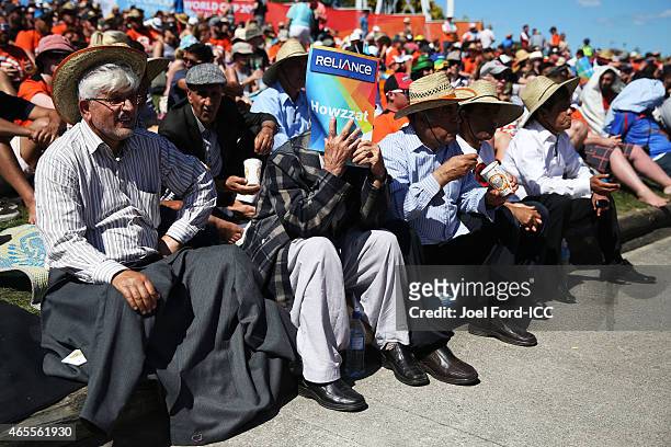 Cricket fan protects his face from the sun using a promotional '6' card during the 2015 ICC Cricket World Cup match between New Zealand and...