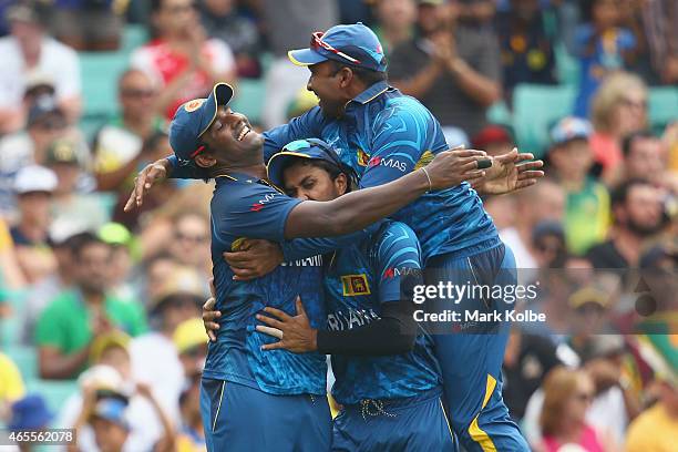 Thisara Perera, Dinesh Chandimal and Mahela Jayawardene of Sri Lanka celebrate after Perera took the catch to dismiss Steve Smith of Australia during...