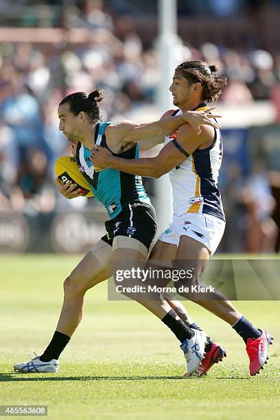 Sharrod Wellingham of the Eagles tackles Kane Mitchell of the Power during the NAB Challenge match between the Port Adelaide Power and the West Coast...