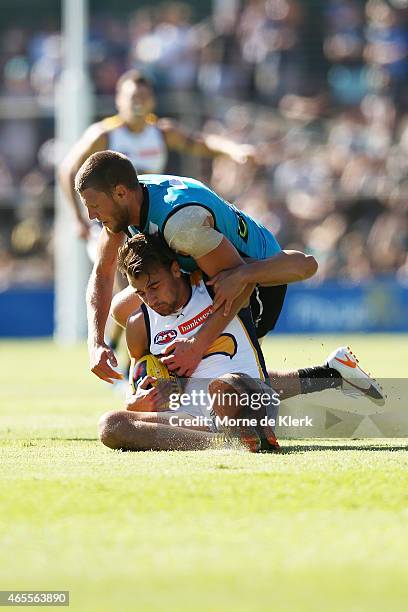 Dom Sheed of the Eagles is tackled by Brad Ebert of the Power during the NAB Challenge match between the Port Adelaide Power and the West Coast...