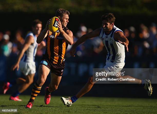 Sam Mitchell of the Hawks runs with the ball during the NAB Challenge AFL match between the North Melbourne Kangaroos and the Hawthorn Hawks at...