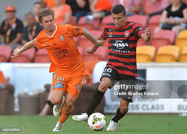 Luke Brattan of the Roar and Jaushua Sotirio of the Wanderers compete for the ball during the round 20 A-League match between the Brisbane Roar and...