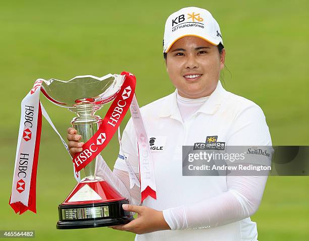 Inbee Park of South Korea poses with the trophy after winning the HSBC Women's Champions at Sentosa Golf Club on March 8, 2015 in Singapore,...