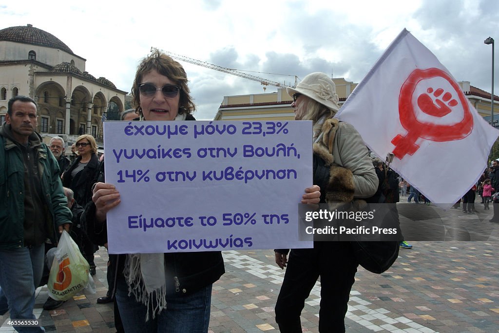 A demonstrator holding a flag with the symbol of feminism...