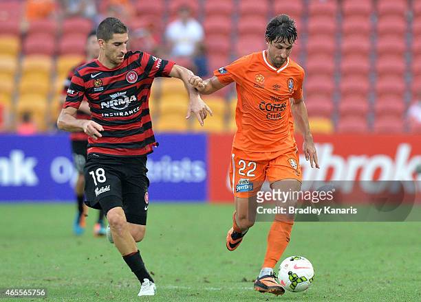 Thomas Broich of the Roar is challenged by Iacopo La Rocca of the Western Sydney Wanderers during the round 20 A-League match between the Brisbane...