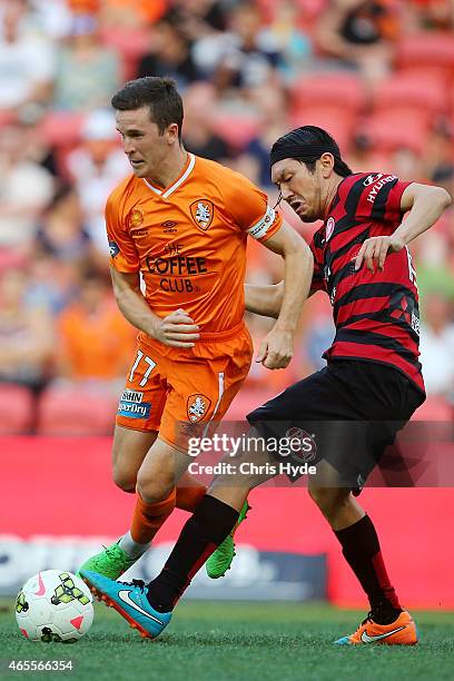 Matthew McKay of the Roar and Yojiro Takahagi of the Wanderers compete for the ball during the round 20 A-League match between the Brisbane Roar and...