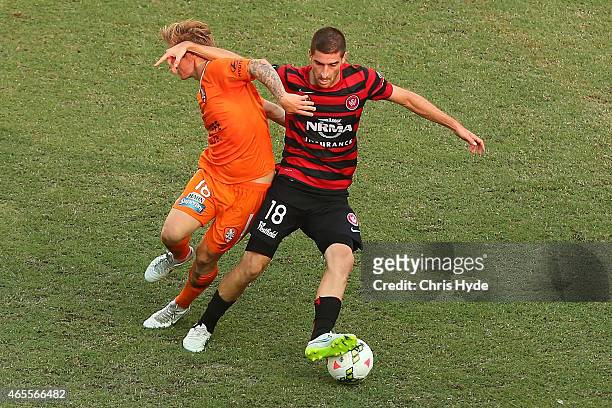 Luke Brattan of the Roar and Lacopo La Rocca of the Wanderers compete for the ball during the round 20 A-League match between the Brisbane Roar and...