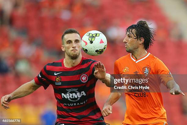 Thomas Broich of the Roar and Matthew Spiranovic of the Wanderers compete for the ball during the round 20 A-League match between the Brisbane Roar...