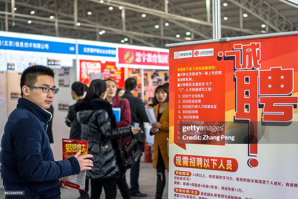 Job seekers in a recruitment fair.    With the slowdown of...