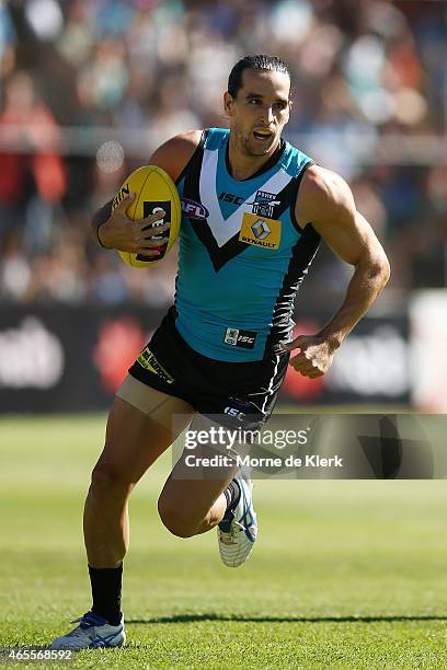 Kane Mitchell of the Power runs with the ball during the NAB Challenge match between the Port Adelaide Power and the West Coast Eagles at Norwood...