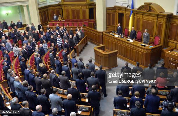Deputies of the Ukrainian parliament during an extra-ordinary session in Kiev on January 28, 2014 stay to commemorate people who died during clashes...
