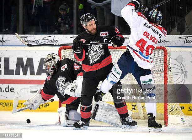 Jochen Reimer, Patrick Reimer of the Thomas Sabo Ice Tigers Nuernberg and Darin Olver of the Eisbaeren Berlin during the game between Thomas Sabo Ice...