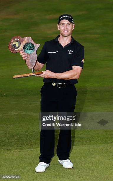 Trevor Fisher Jnr of South Africa poses with the trophy after winning the Africa Open at East London Golf Club on March 8, 2015 in East London, South...